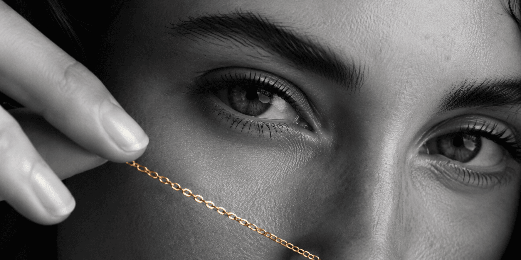Auricn campaign — a fine gold chain held across the face